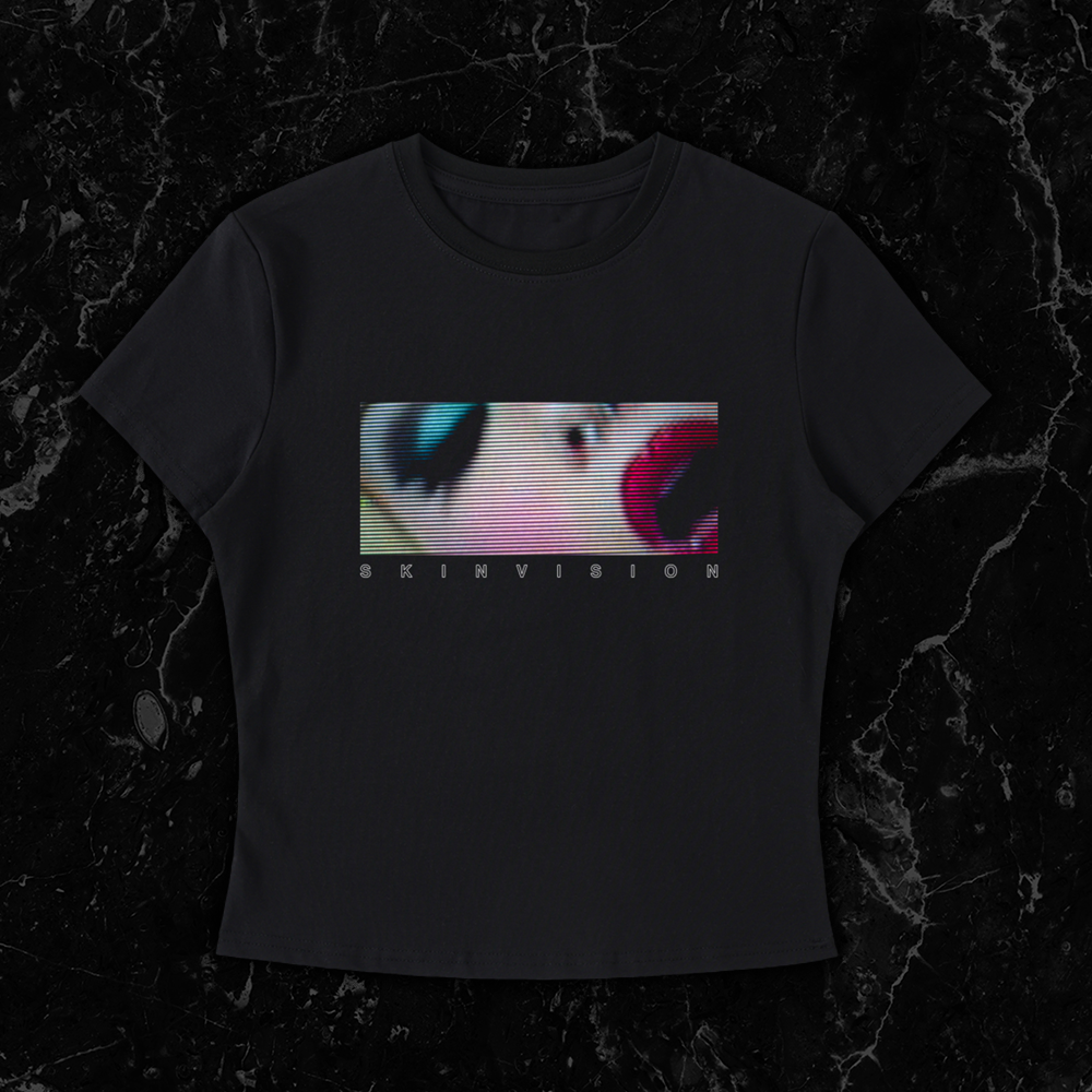 Black shirt featuring a horizontal letterbox-style image of a woman’s face from SkinVision’s Pussygeist video, in a distorted CRT TV scanline style by SkinVision