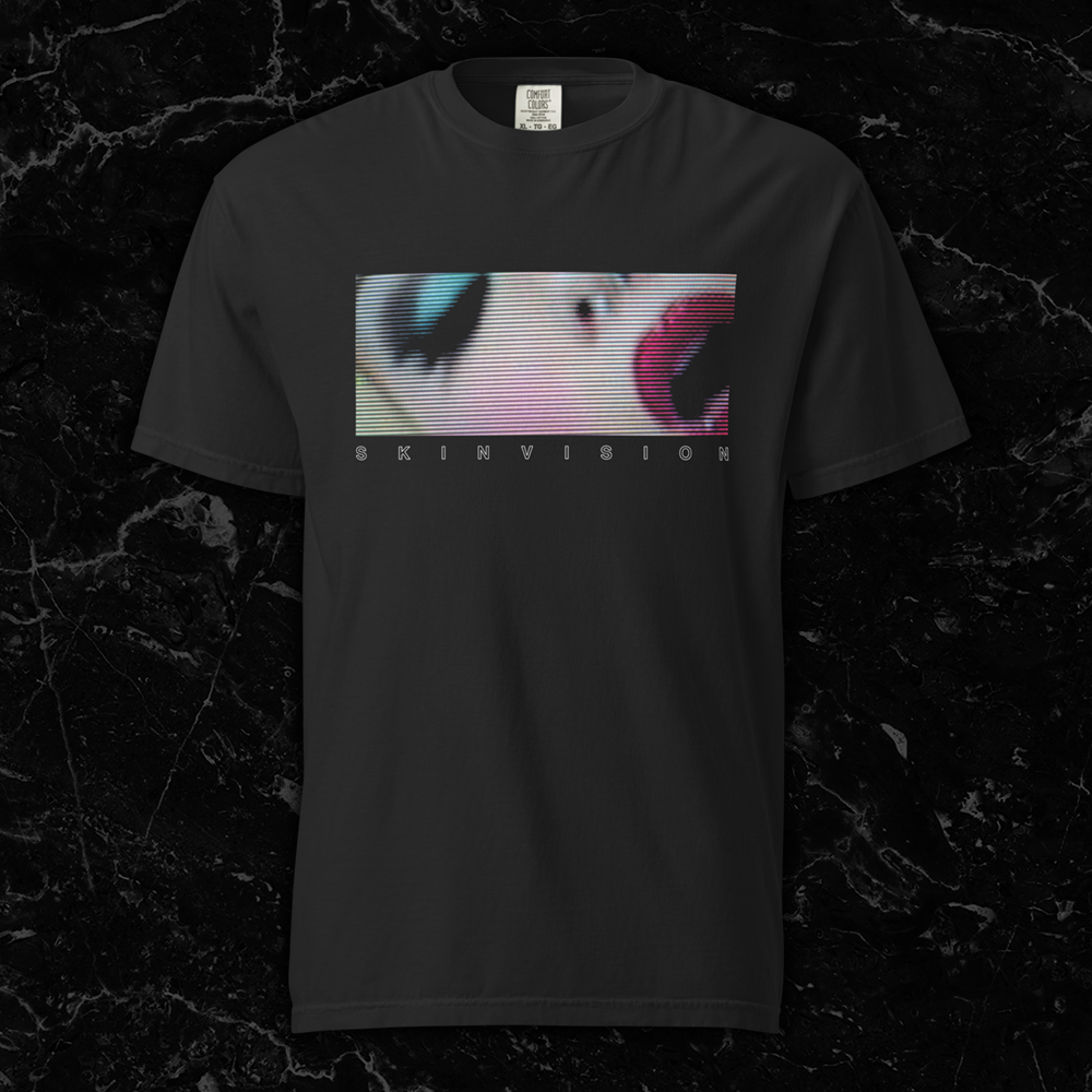 Black t-shirt featuring a horizontal letterbox-style image of a woman’s face from SkinVision’s Pussygeist video, in a distorted CRT TV scanline style by SkinVision